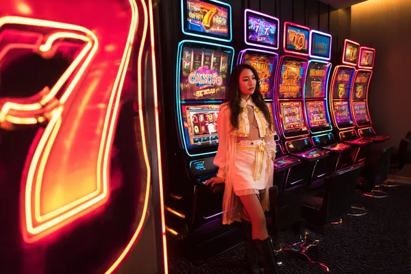 A confident dealer surrounded by casino chips inviting players to access their 5XGAME account, reflecting quick and easy login options.